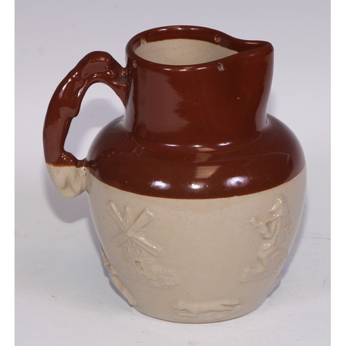 747 - A Royal Doulton brown and buff salt glazed stoneware ovoid harvest jug, typically sprigged with joll... 