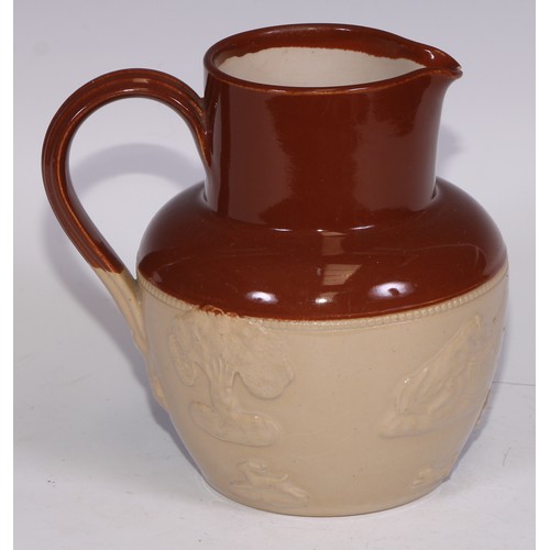 747 - A Royal Doulton brown and buff salt glazed stoneware ovoid harvest jug, typically sprigged with joll... 