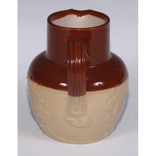 747 - A Royal Doulton brown and buff salt glazed stoneware ovoid harvest jug, typically sprigged with joll... 