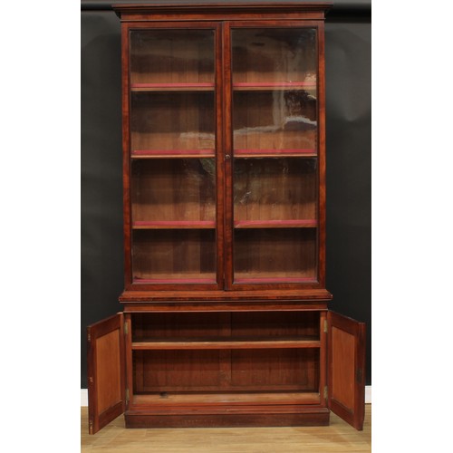 345 - A 19th century mahogany library bookcase, outswept cornice above a pair of glazed doors enclosing ad... 