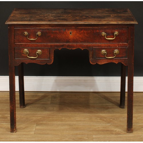 423 - A George III oak lowboy, rectangular top above three drawers, shaped apron, internally chamfered leg... 