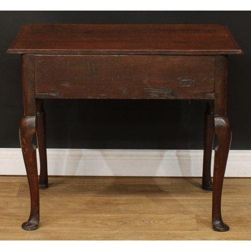 418 - A George III mahogany crossbanded oak side table, slightly oversailing top above a long drawer, bras... 