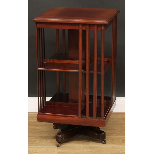 515 - An Edwardian mahogany revolving bookcase, square top with moulded edge above an arrangement of shelv... 