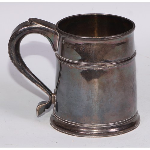 18 - A Queen Anne Britannia silver mug, quarter girdle, S-scroll handle, skirted base, 12cm high, Anthony... 