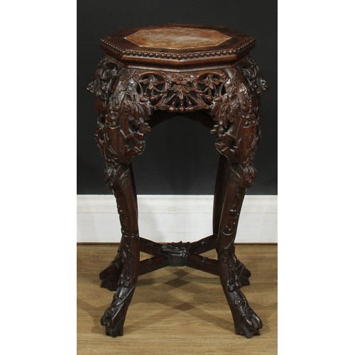 351 - A Chinese hardwood jardiniere stand, octagonal top with inset soapstone panel above a shaped and pie... 