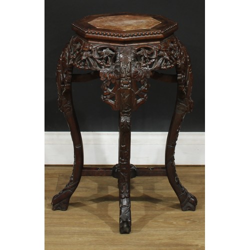 351 - A Chinese hardwood jardiniere stand, octagonal top with inset soapstone panel above a shaped and pie... 