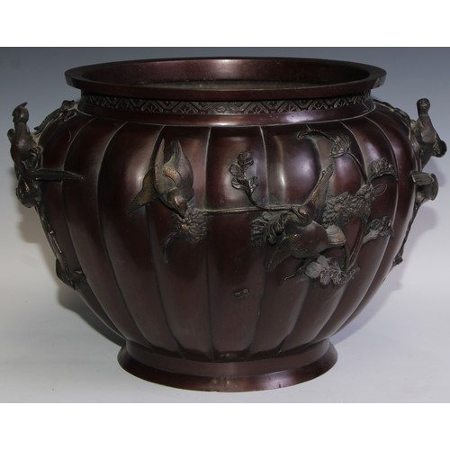 388 - A large Japanese brown patinated bronze fluted ovoid jardiniere, cast and applied with song birds on... 