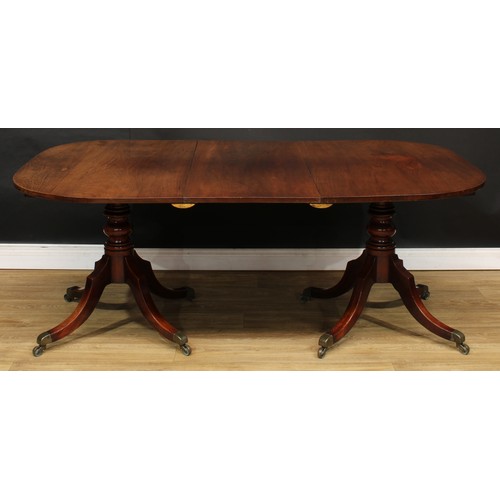 420 - A George III mahogany twin-pillar dining table, rounded rectangular top with one additional leaf, ea... 