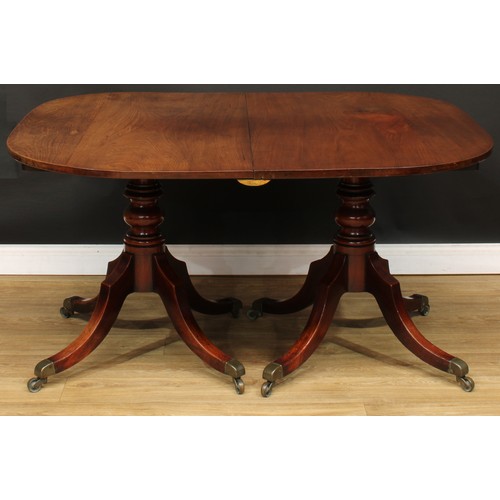 420 - A George III mahogany twin-pillar dining table, rounded rectangular top with one additional leaf, ea... 