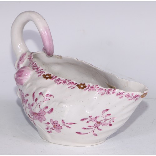 675 - A Derby Cos Lettuce sauce boat, decorated in tones of pink with flowering sprigs picked out in gilt,... 