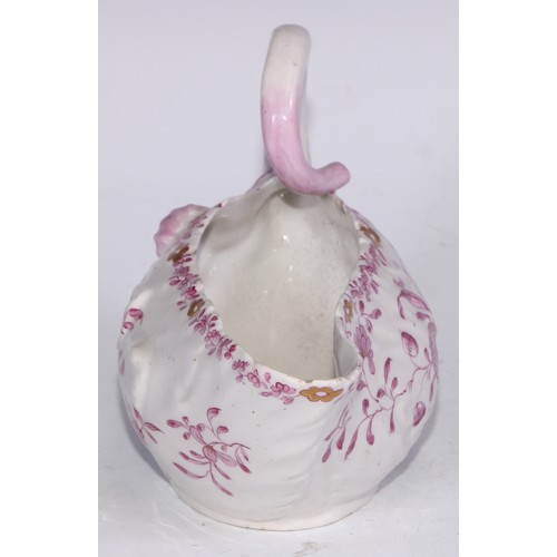 675 - A Derby Cos Lettuce sauce boat, decorated in tones of pink with flowering sprigs picked out in gilt,... 