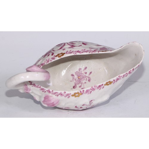 675 - A Derby Cos Lettuce sauce boat, decorated in tones of pink with flowering sprigs picked out in gilt,... 