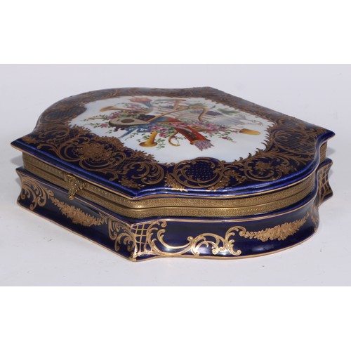 384 - A Continental gilt metal mountede porcelain casket, decorated in polychrome with a musical trophy, t... 