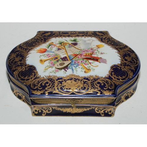 384 - A Continental gilt metal mountede porcelain casket, decorated in polychrome with a musical trophy, t... 