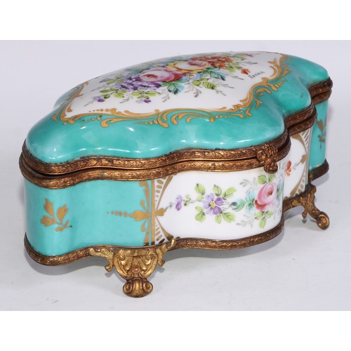 383 - A Continental gilt metal mounted porcelain shaped serpentine casket, decorated with reserves of flow... 