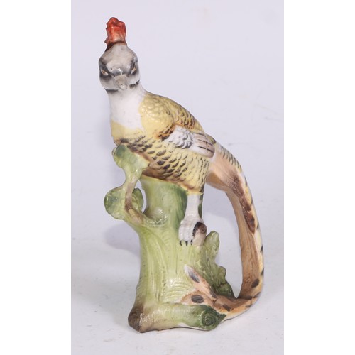 728 - A Continental porcelain model, of a parrot, perched upon an oak tree stump, coloured in tones of gre... 