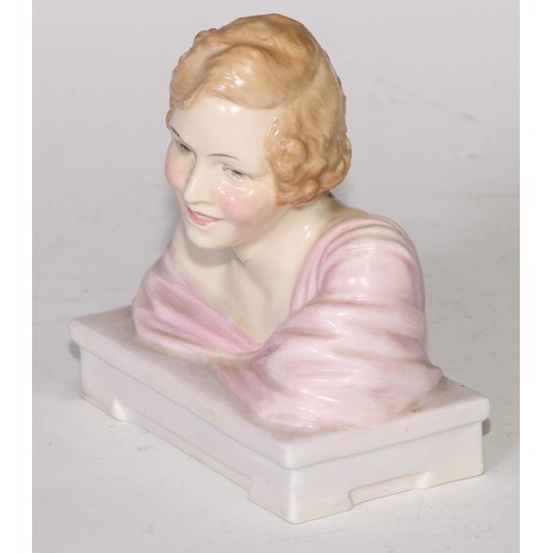 748 - A Royal Doulton bust length figure, Gladys, modelled as a young Art Deco lady leaning on a ledge, 17... 