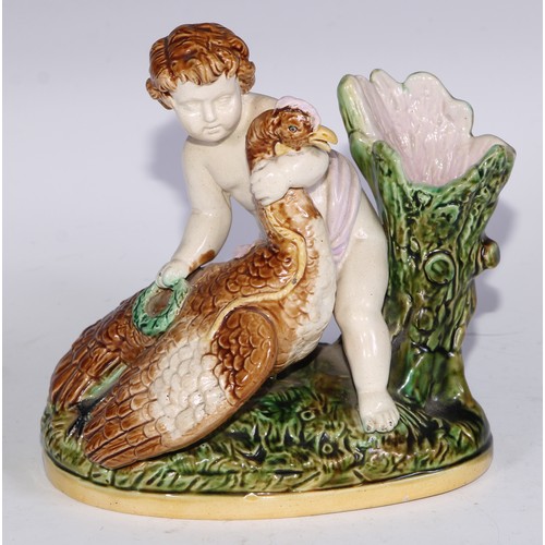 736 - A Majolica figural spill vase, modelled as a putto with a bird, 15.5cm wide; a pair of Staffordshire... 