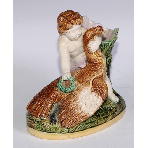 736 - A Majolica figural spill vase, modelled as a putto with a bird, 15.5cm wide; a pair of Staffordshire... 