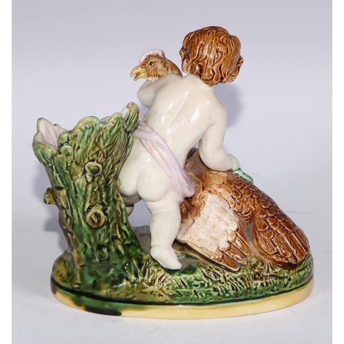 736 - A Majolica figural spill vase, modelled as a putto with a bird, 15.5cm wide; a pair of Staffordshire... 