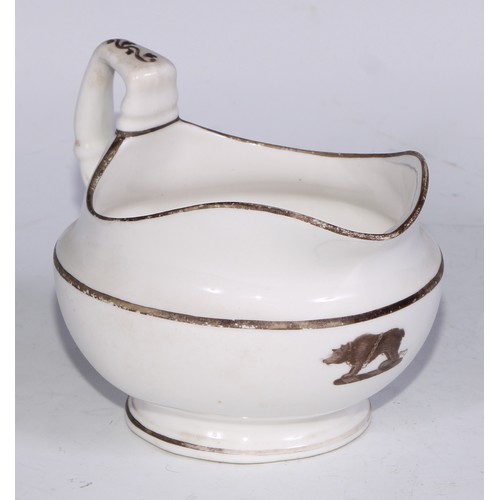 669 - A Derby armorial helmet shaped cream jug, printed in monochrome with a heraldic crest, 15cm long, c.... 