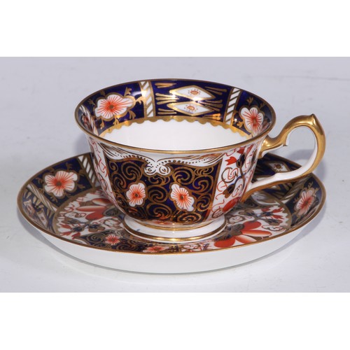 638 - A Royal Crown Derby Imari sucrier and cover, 15cm wide, printed mark; an 1128 pattern tea cup; a 245... 