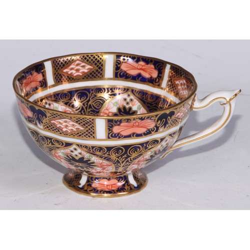 638 - A Royal Crown Derby Imari sucrier and cover, 15cm wide, printed mark; an 1128 pattern tea cup; a 245... 