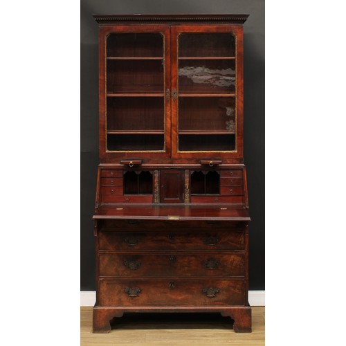 416 - A George III mahogany bureau bookcase, dentil cornice above a pair of glazed doors enclosing adjusta... 