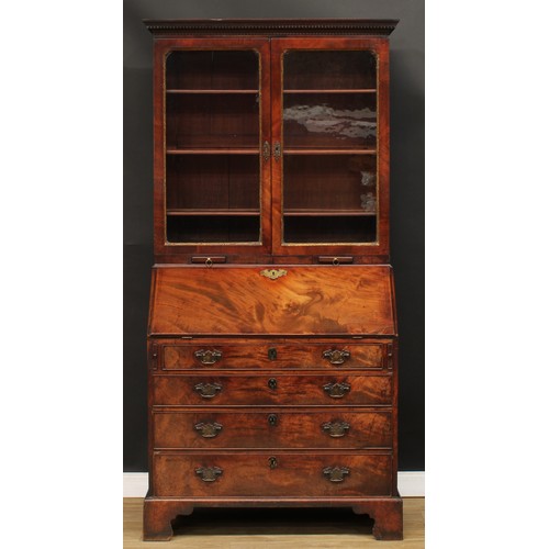 416 - A George III mahogany bureau bookcase, dentil cornice above a pair of glazed doors enclosing adjusta... 