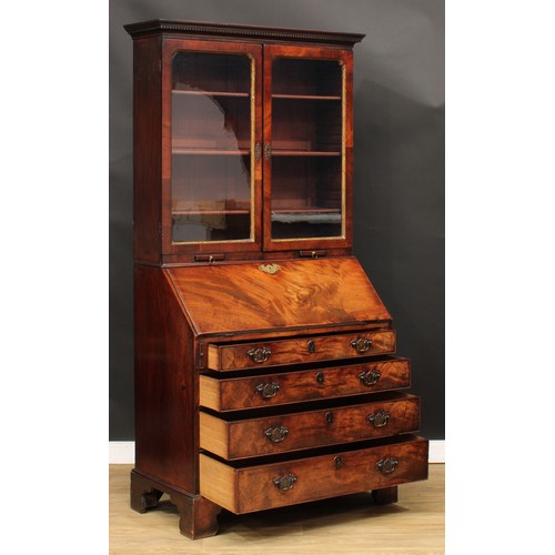 416 - A George III mahogany bureau bookcase, dentil cornice above a pair of glazed doors enclosing adjusta... 