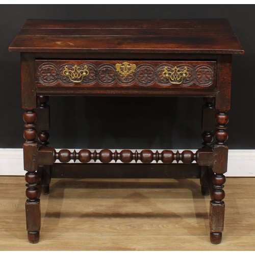 497 - An 18th century oak side table, planked rectangular top above a long frieze drawer, the front later ... 