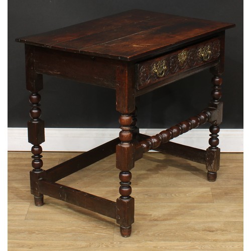 497 - An 18th century oak side table, planked rectangular top above a long frieze drawer, the front later ... 