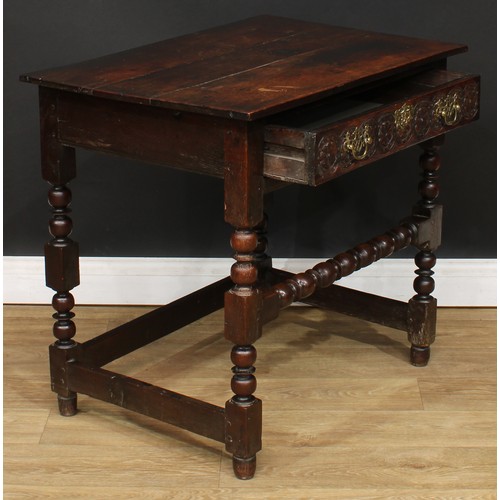 497 - An 18th century oak side table, planked rectangular top above a long frieze drawer, the front later ... 