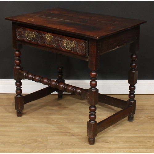 497 - An 18th century oak side table, planked rectangular top above a long frieze drawer, the front later ... 