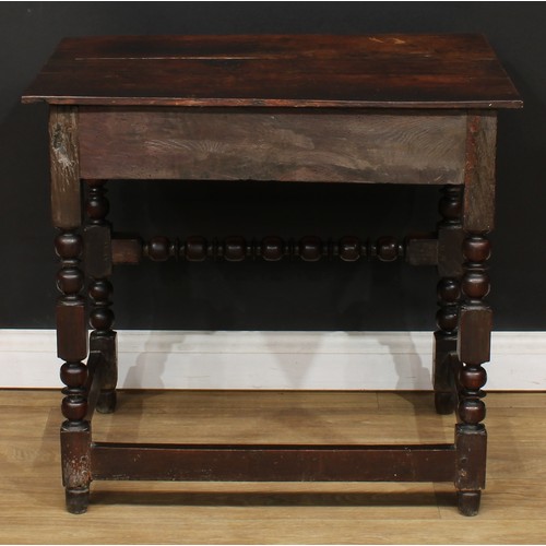 497 - An 18th century oak side table, planked rectangular top above a long frieze drawer, the front later ... 