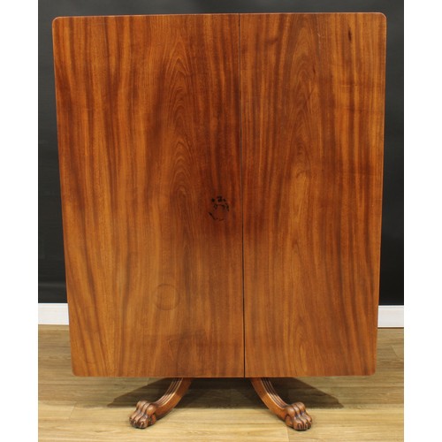 468 - A mahogany breakfast table, rounded rectangular titling top, turned column, reeded legs, paw feet, 7... 