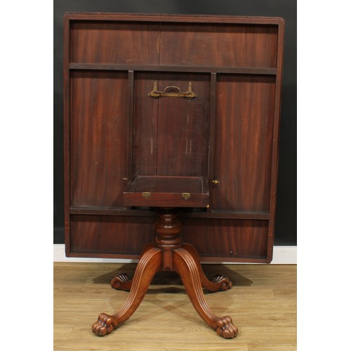 468 - A mahogany breakfast table, rounded rectangular titling top, turned column, reeded legs, paw feet, 7... 