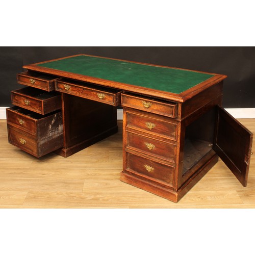 522 - An oak twin pedestal desk, rectangular top with inset writing surface above three frieze drawers, on... 