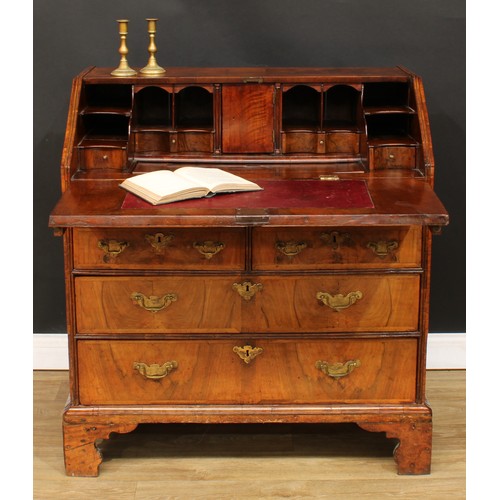 355 - A George II feather-banded walnut bureau, crossbanded fall front enclosing a well with secret compar... 