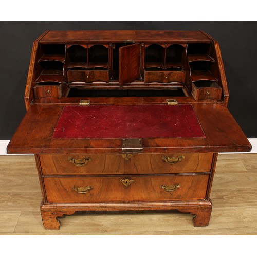 355 - A George II feather-banded walnut bureau, crossbanded fall front enclosing a well with secret compar... 