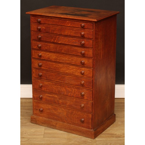 513 - An early 20th century oak collector’s chest, rectangular top above ten long drawers, 84cm high, 56cm... 