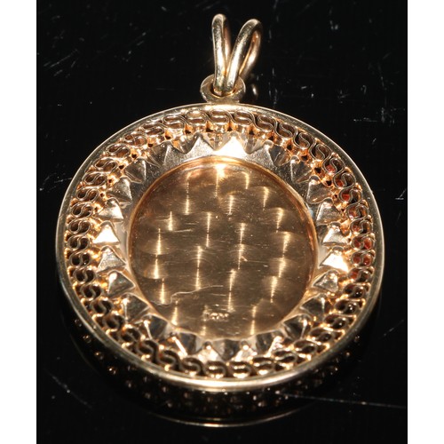 110 - A 14ct gold oval pendant, pierced with a band of wirework, engraved to the centre, 5cm high over loo... 