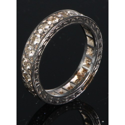 168 - A diamond eternity ring, set with a continuous single row of brilliant cut stones, engraved white me... 