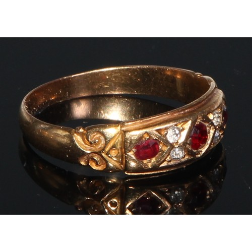 244 - An 18ct gold ring, set with three rubies divided by four small diamonds, engraved with scrolls to sh... 