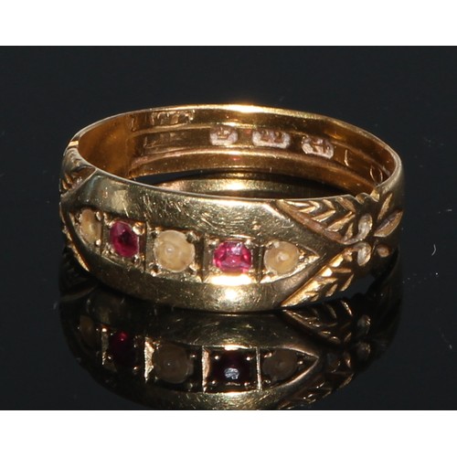 244 - An 18ct gold ring, set with three rubies divided by four small diamonds, engraved with scrolls to sh... 