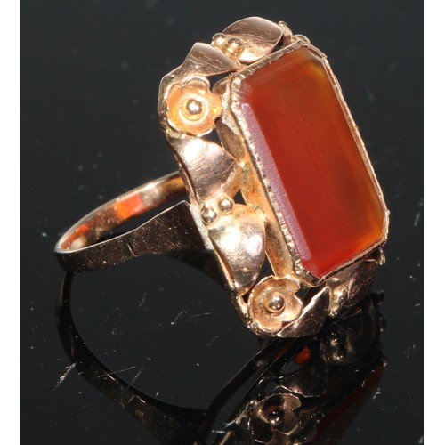 207 - A Russian 14ct gold ring, the large tablet set with a canted rectangular agate panel, within openwor... 