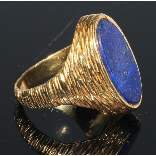 186 - A large 18ct gold seal ring, the shoulders and shank textured, oval lapis lazuli panel, size S, 24g ... 