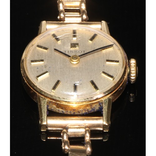 184 - A ladies 9ct gold Tissot wristwatch, the 1.8cm champagne dial with baton markers, 13.g gross