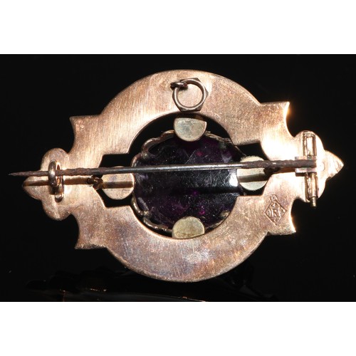 231 - A Victorian Scottish hardstone and amethyst gold coloured metal brooch, the large central claw set c... 