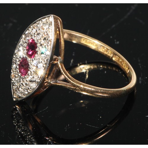 163 - A diamond and ruby navette shaped 18ct gold ring, the two central facet cut rubies within a field of... 